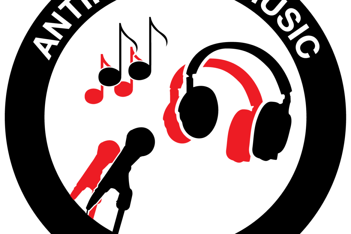 Logo of Antifascist Music Alliance. A black circle which is white on the edges. 'Antifascist Music' is written at the top part in white letters. And at the bottom 'Alliance' is written, also in white. In the middle there are drawings of a music note, headphones and microphone all in red and black on a white backdrop