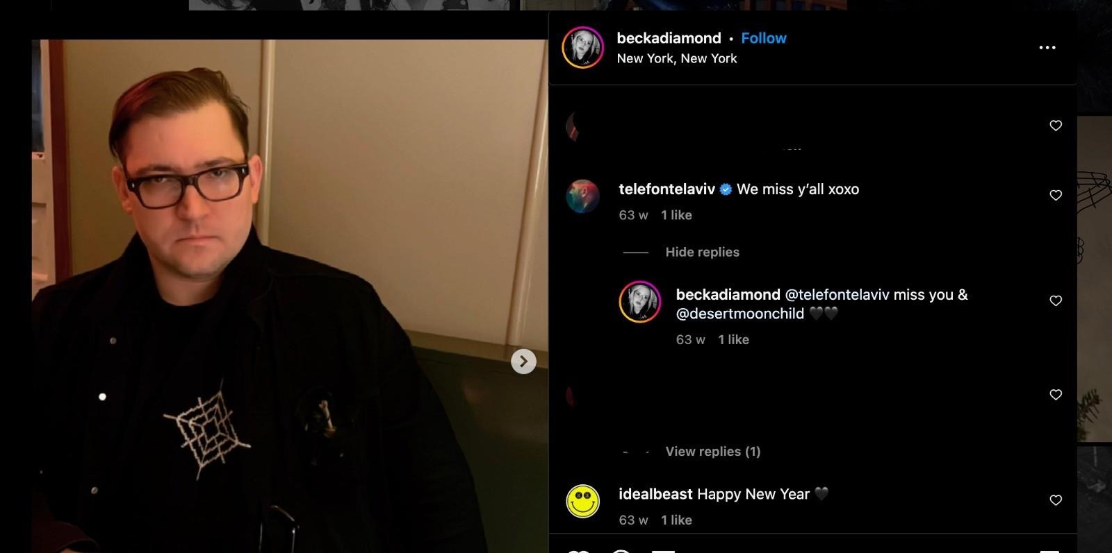 Instagram post from user @beckadiamond, showing at left an image of Dominick Fernow with a black jacket and a white patch or design on a shirt of a spider web or target design. At right, a comment is visible from @telefontelaviv, commenting "We miss y'all xoxo", under which @beckadiamond commented "@telefontelaviv miss you & @desertmoonchild" with two black heart emoji. Underneath, there is a comment from user @idealbeast, "Happy New Year" with a black heart emoji.