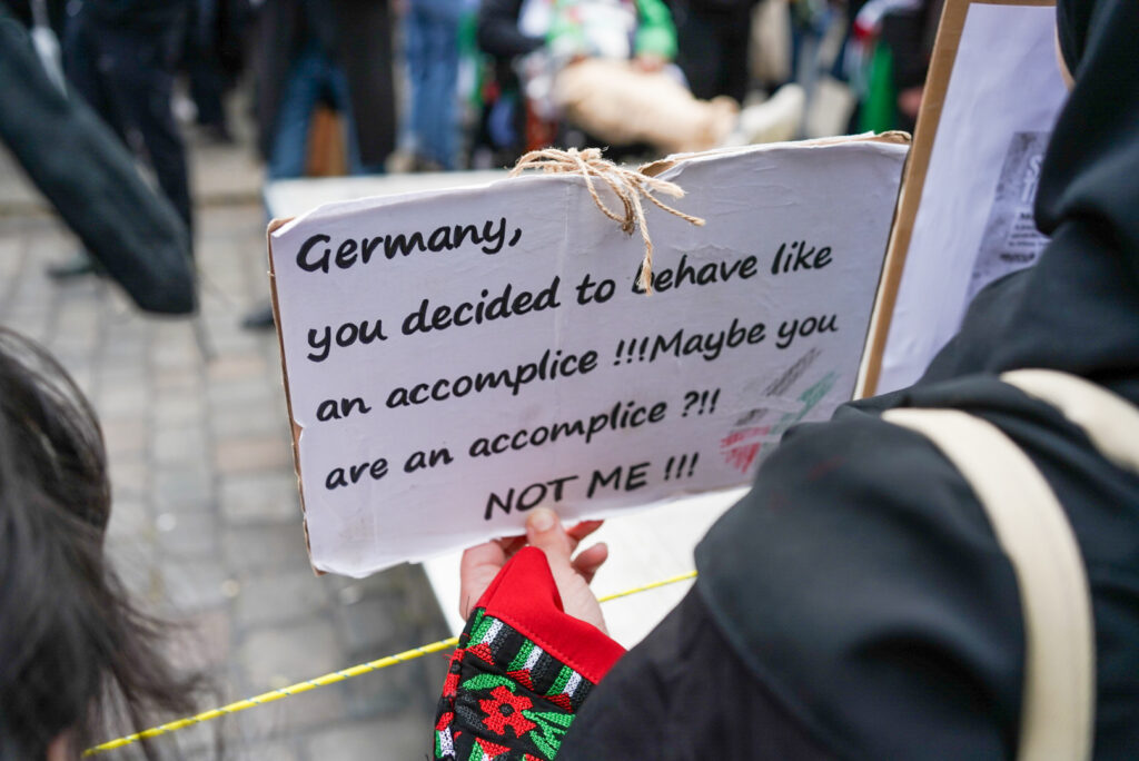 Sign from Nakba Day, reads, “Germany, you decided to behave like an accomplice!!! Maybe you are an accomplice?! Not me!!!"